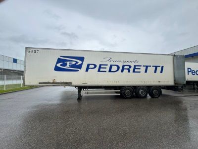 un semi-remorque garé devant un immeuble