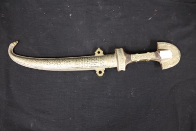 a close up of a knife on a black surface