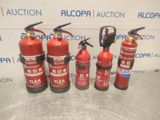 four fire extinguisors are lined up on a table