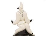 a figurine of a man sitting on top of a table
