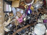 a box full of assorted jewelry on a table
