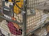a metal cage filled with lots of stuff on the ground