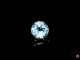 a close up of a blue diamond on a black surface