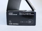 a black box with a microphone in it on a white surface