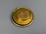 a close up of a gold plate with a smiley face on it