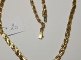 a gold necklace with a chain that has a lock on it