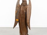 an old wooden statue of an angel with wings on a pedestal