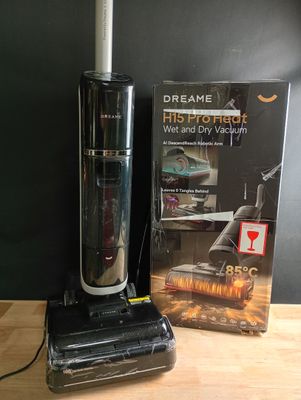 a vacuum that is sitting on a table next to a book