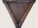 an image of a wooden triangle shaped object on a wall