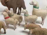a lot of toy animals that are on a white surface