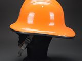 an orange hard hat sitting on top of a black mannequin head