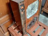 a clock that is sitting on a stand in a room