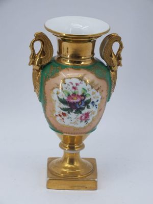 a gold vase with a floral design on it