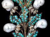 une image représentant une broche ornée de perles et de pierres de turquoise