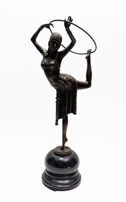 bronze statue of a woman holding a hoop on a black base