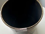 a black pot sitting on top of a white table