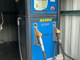 a blue gas pump with a hose attached to it