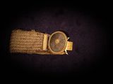an image of a wrist watch on a black surface