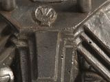 a close up of a metal object on a white surface