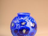 a blue vase sitting on top of a black stand