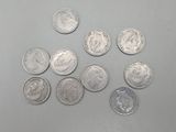 several different types of coins are arranged on a gray surface