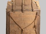 an old wooden door with a rope hanging from it ' s side