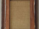 an old picture frame with a picture hanging on the side of it