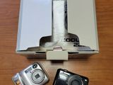 un appareil photo, un téléphone portable et une boîte posée sur une table