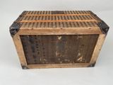 an old wooden box sitting on top of a white surface