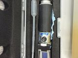 a black case with a flashlight and a pen in it