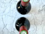 two bottles of wine sitting on a marble table