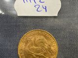 a gold coin with a label on it sitting on top of a table