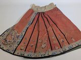 an orange skirt with black trim and a floral design on the bottom
