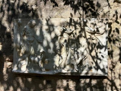 a stone plaque on the side of a stone wall