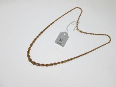 a close up of a gold chain with a tag on it
