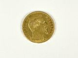 a close up of a gold coin on a white surface