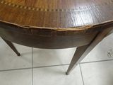 a wooden table with a wooden top on a tile floor