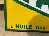 a yellow and green sign on the side of a building