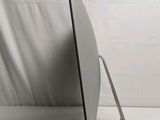 a laptop computer sitting on a stand on a white surface