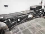 a black plastic sheet covering a bed in a room