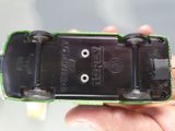 a person holding a green and black skateboard in their hand