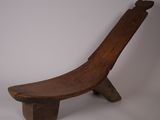 an old wooden bench sitting on top of a white surface