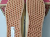 the soles of a pair of shoes are shown in front of a box