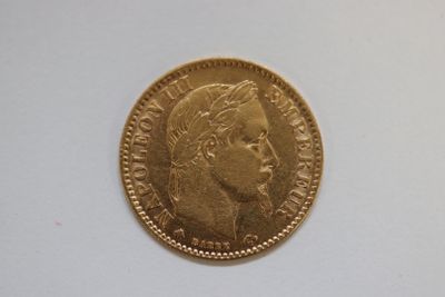 a close up of a gold coin with a man ' s face on it