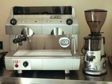 a coffee machine and a grinder sitting on a counter