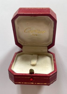 a red box with a gold ring inside of it