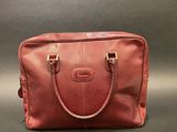 a red leather handbag on a grey background