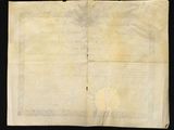 a piece of old paper with writing on it on a black surface