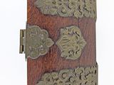 a small wooden book with ornate designs on it