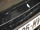 a close up of a black car with a license plate on it